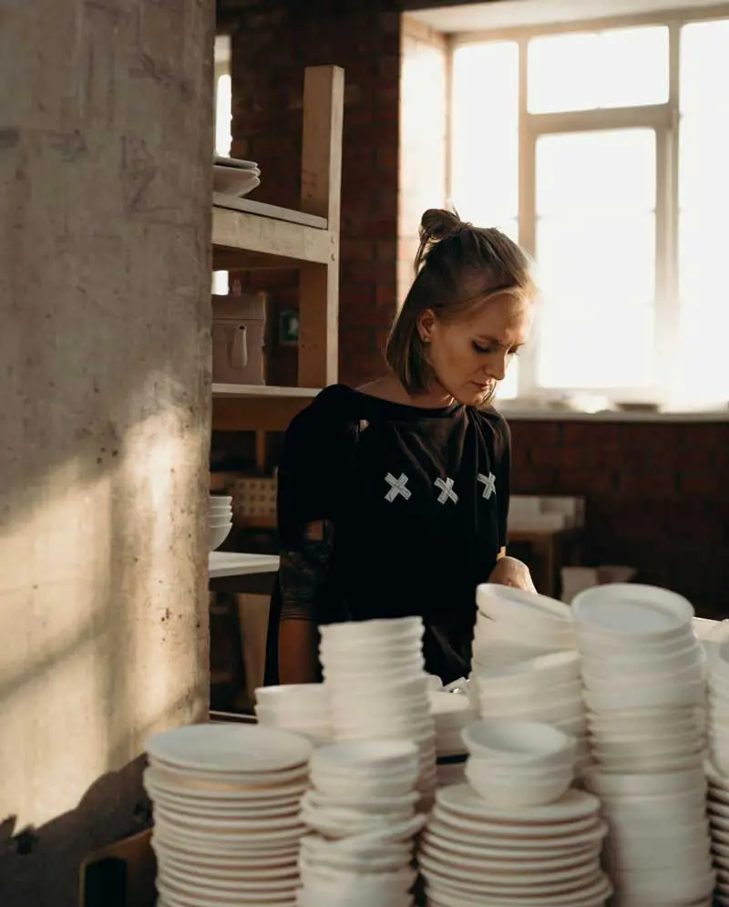 Woman making ceramic plates